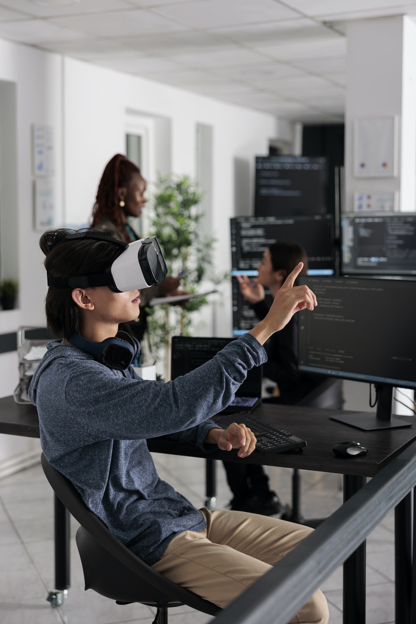 Software developer wearing virtual reality headset working to develop security program